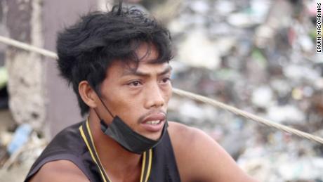 Jay Lacia sits among crumbled homes, fallen trees and broken power cables. He lost everything when Super Typhoon Rai hit the Philippines on December 16. 