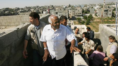 Desmond Tutu, center, visits a house in the town of Beit Hanun in the northern Gaza Strip on May 28, 2008.