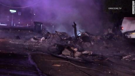 Wreckage of a plane crash covers a street in El Cajon, California.