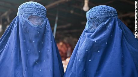 Afghan women are seen at a market in Kabul on December 20, 2021.
