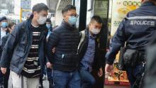 Editor of &quot;Stand News&quot; Patrick Lam, second from left, is arrested by police officers in Hong Kong, Wednesday, Dec. 29, 2021. Hong Kong police say they have arrested seveal current and former staff members of the online media company for conspiracy to publish a seditious publication. (AP Photo/Vincent Yu)