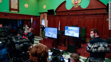 Journalists watch television coverage of Wednesday&#39;s hearing.