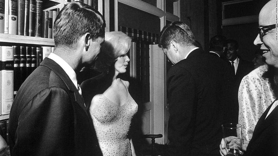 President John F. Kennedy (with his back to the camera), US Attorney General Robert Kennedy (far left), and Monroe on the President&#39;s 45th birthday. Monroe flew to New York to sing him a very erotic version of &quot;Happy Birthday.&quot; She wore a beige rhinestone-encrusted dress. It&#39;s said the dress was so tight that she had to be sewn into it before getting on stage.&lt;br /&gt;&lt;br /&gt;&quot;I was honored when they asked me to appear at Madison Square Garden. You know, I was a little worried about my voice, but it came out,&quot; Monroe said.&lt;br /&gt;&lt;br /&gt;The dress sold for &lt;a href=&quot;https://www.cnn.com/style/article/marilyn-monroe-dress-new-record/index.html&quot; target=&quot;_blank&quot;&gt;$4.8 million in an auction 2016, &lt;/a&gt;breaking its own record as the most expensive personal item of clothing.