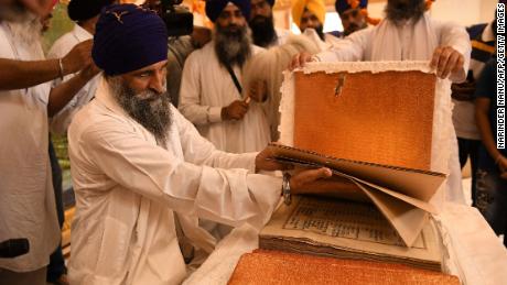 Sikh priest Giani Gurmukh Singh with the Guru Granth Sahib, the Sikh holy book, in the Golden Temple in Amritsar on June 3, 2021. 