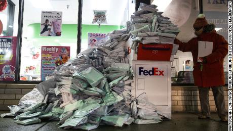 Covid-19 tests at home by Chicago Public Schools students pile up Tuesday at a FedEx filing box.