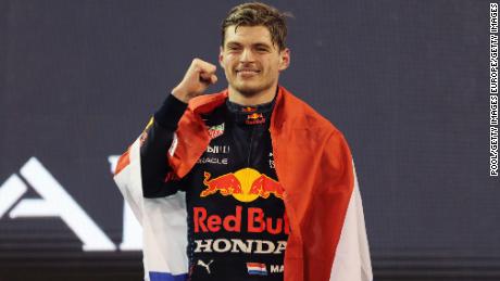 Max Verstappen celebrates on the podium after winning his maiden world title. 
