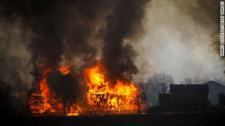 Two homes burn in Louisville, Colorado, on Thursday.