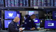 Traders work on the trading floor at the New York Stock Exchange (NYSE) in Manhattan, on December 28, 2021. 