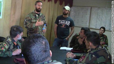 Drew Horn (left, standing) speaks with members of the Afghan military.