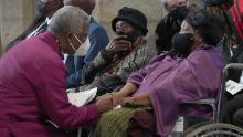 Archbishop of Cape Town Thabo Makgoba (L) greets Leah Tutu (R), widow of South African anti-Apartheid icon Archbishop Desmond Tutu, during Tutu&#39;s requiem mass at St. Georges Cathedral in Cape Town on January 1, 2022. - Tutu died on December 26, 2021 at the age of 90, triggering grief among South Africans and tributes from world leaders for a life spent fighting injustice. (Photo by Nic BOTHMA / POOL / AFP) (Photo by NIC BOTHMA/POOL/AFP via Getty Images)