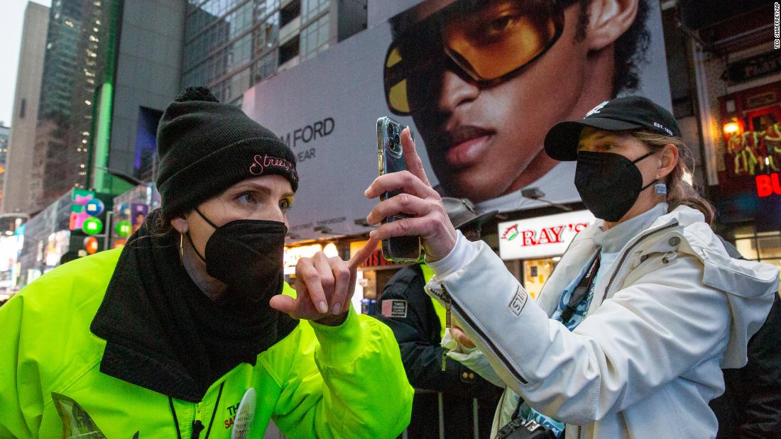 A woman shows proof of vaccination against Covid-19 to enter Times Square for the New Year&#39;s Eve ball drop in New York on Friday, December 31.