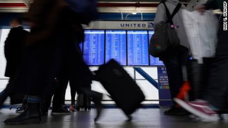 Travellers walk through Terminal 1 at O&#39;Hare International Airport in Chicago, Thursday, Dec. 30, 2021. (AP Photo/Nam Y. Huh)