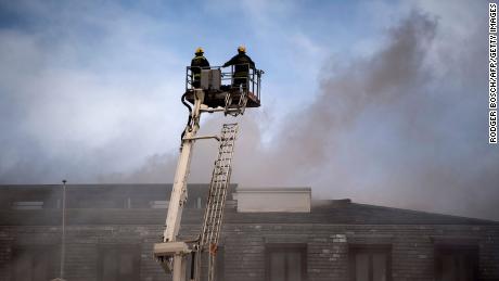 A raised firefighting platform is moved close to the roof of the National Assembly building in the parliamentary complex.