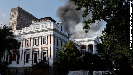 Smoke billows from the roof of a building at parliament.  
