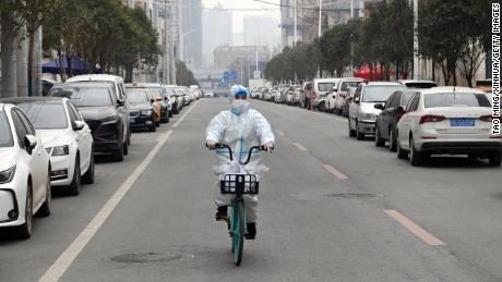 A staff member of a drug store rides a bicycle to deliver medicine in Xi&#39;an, northwest China, Dec. 31, 2021.