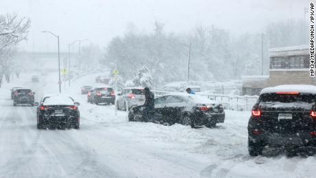 A car became stranded on a highway in Alexandria, Virginia, as a winter snow storm paralyzed traffic in the northern Virginia region on Monday.