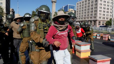 Beekeepers who demanded government help amid a damaging drought are detained at a protest in Santiago, Chile on Monday. 