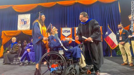 Salazar pushed Neira across the graduation stage to accept their college degrees.