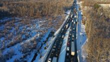 STAFFORD COUNTY, VIRGINIA - JANUARY 04: In an aerial view, traffic creeps along Virginia Highway 1 after being diverted away from I-95 after it was closed due to a winter storm on January 04, 2022 near Fredericksburg in Stafford County, Virginia. A winter storm with record snowfall slammed into the Mid-Atlantic states, stranding thousands of motorists overnight on 50 miles of I-95 in Virginia.  (Photo by Chip Somodevilla/Getty Images)