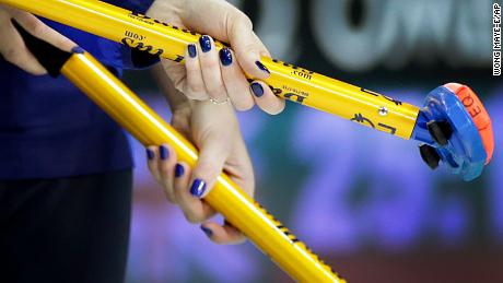 Sweden&#39;s Margaretha Sigfridsson (left) and Maria Prytz hold onto their brooms during the women&#39;s curling semifinal against Switzerland at the 2014 Winter Olympics.