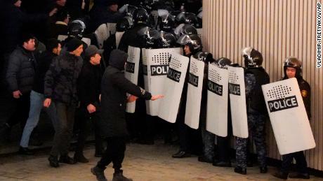 Protesters and riot police in Almaty on Wednesday.