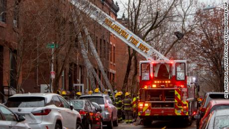 The Philadelphia fire department works at the scene of a deadly row house fire in Philadelphia on Wednesday.