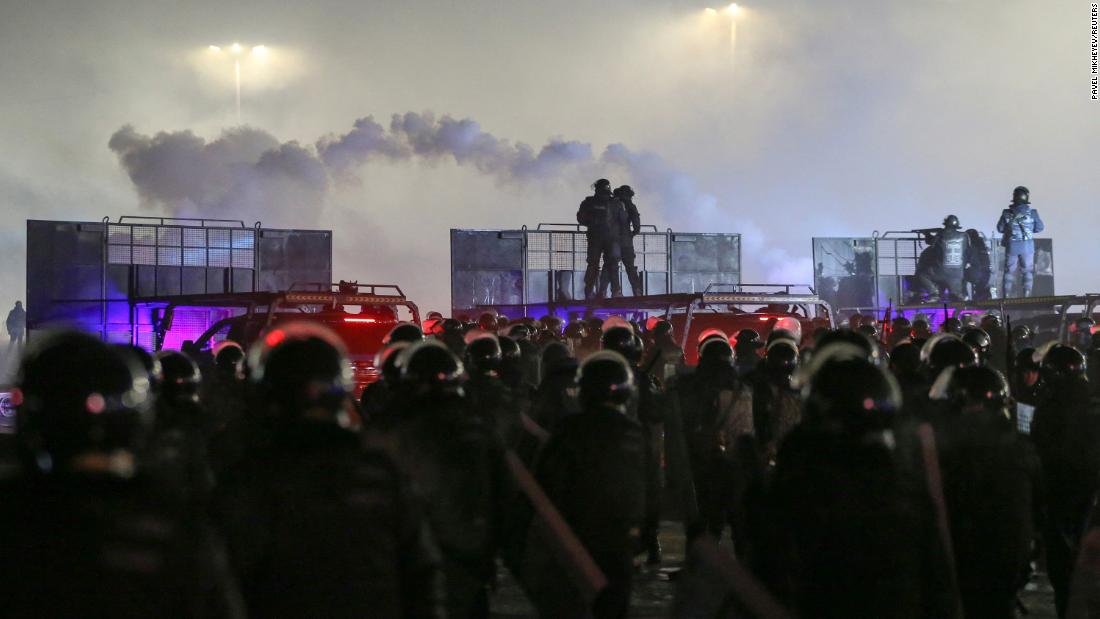 Police officers stand guard during a protest in Almaty on January 4.