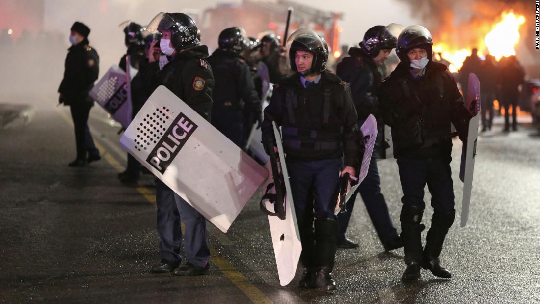 Police officers gather in a square during a protest in Almaty.