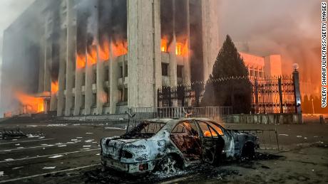 A burnt car is seen by the mayor&#39;s office on fire in Almaty, Kazakhstan on January 5. 