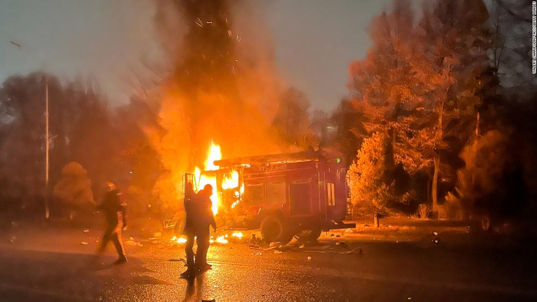 A burning car is seen close to the mayor&#39;s office in Almaty on January 5.