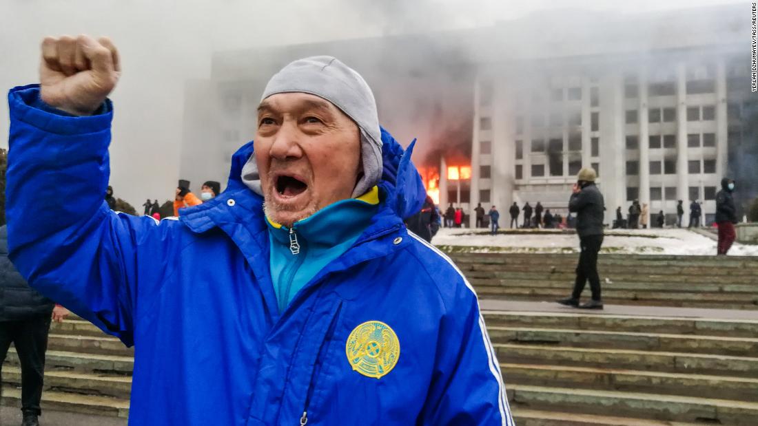 A man protests outside the burning mayor&#39;s office in Almaty on January 5.