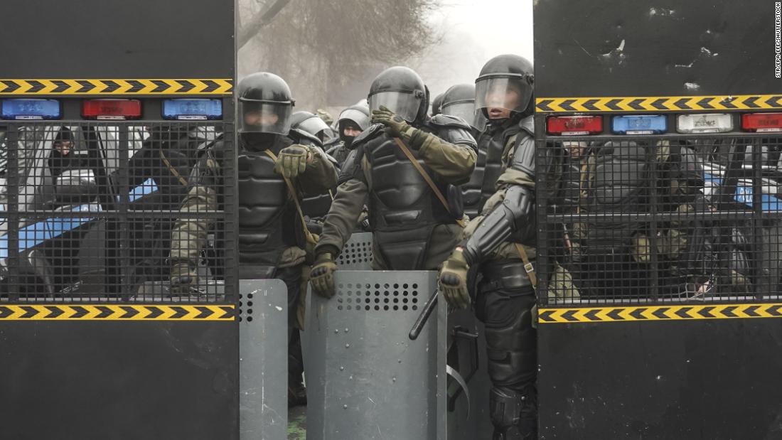 Police officers wear riot gear during a protest in Almaty on January 5.