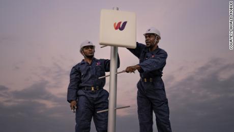 Workers install a World Mobile node as it constructs its land-air network.