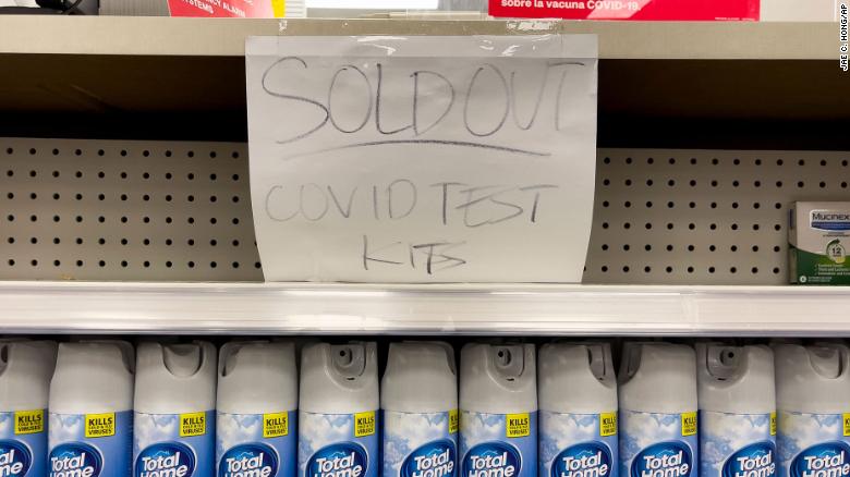 A handwritten notice is posted on an empty shelf after at-home Covid-19 test kits were sold out at a CVS store in La Habra, California.
