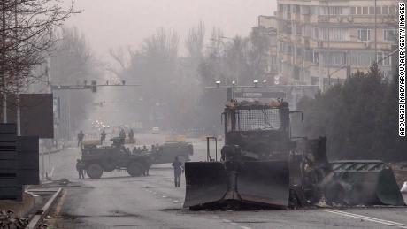 Servicemen and their military vehicles block a street in central Almaty on January 7.