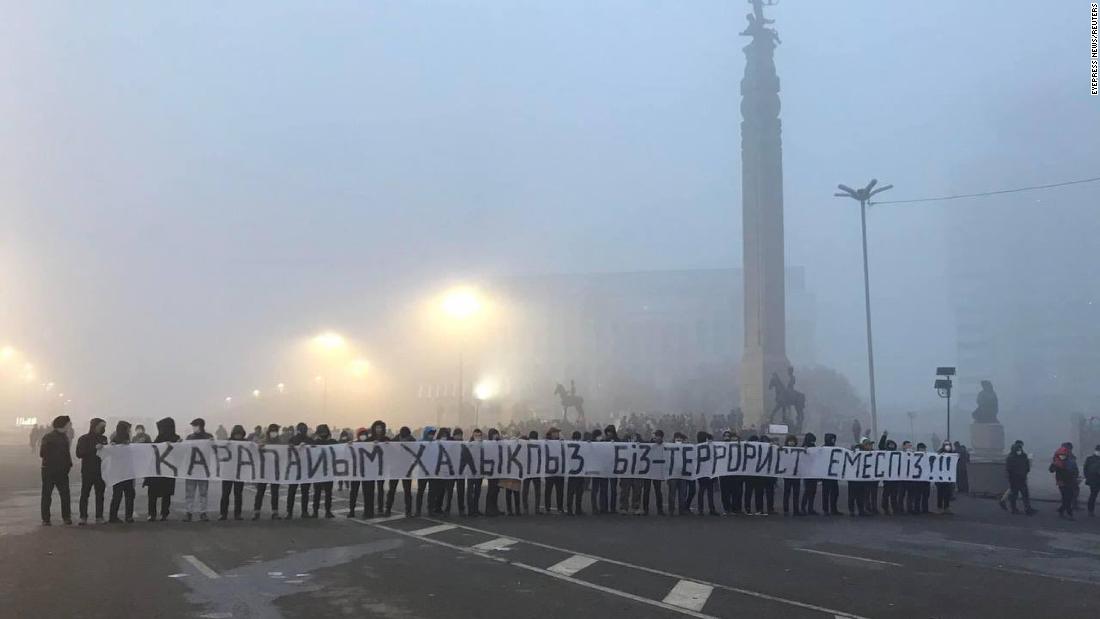 Protesters hold a long banner that reads &quot;We are the people, not terrorists&quot; at the Republic Square in Almaty on January 7. 