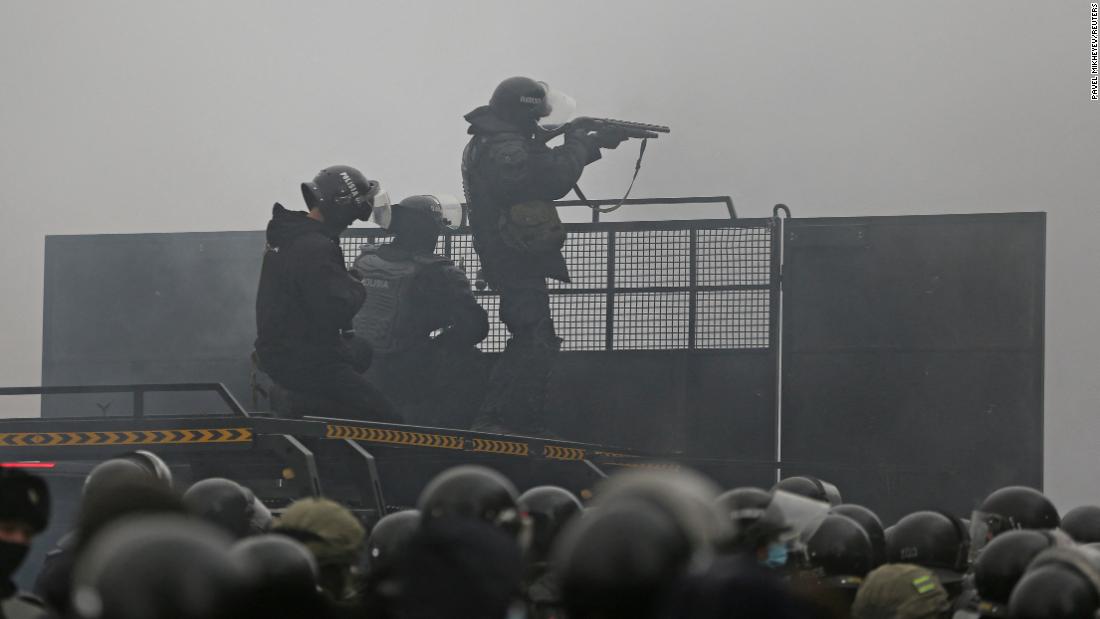Police officers are seen on a barricade in Almaty on January 5.