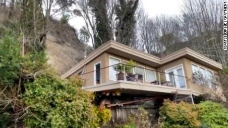 Seattle firefighters rescued a man trapped in the basement of his house during a landslide.