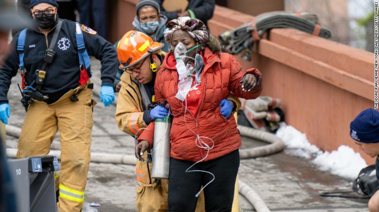 A woman is assisted by rescue personnel January 9.