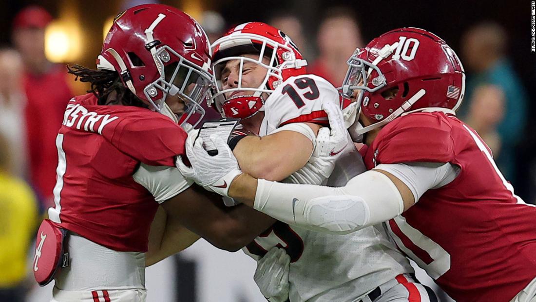 Bowers is tackled by Kool-Aid McKinstry, left, and Henry To&#39;oTo&#39;o during the first half. The opening 30 minutes were a defensive struggle between the two teams, and Alabama led 9-6 at halftime.
