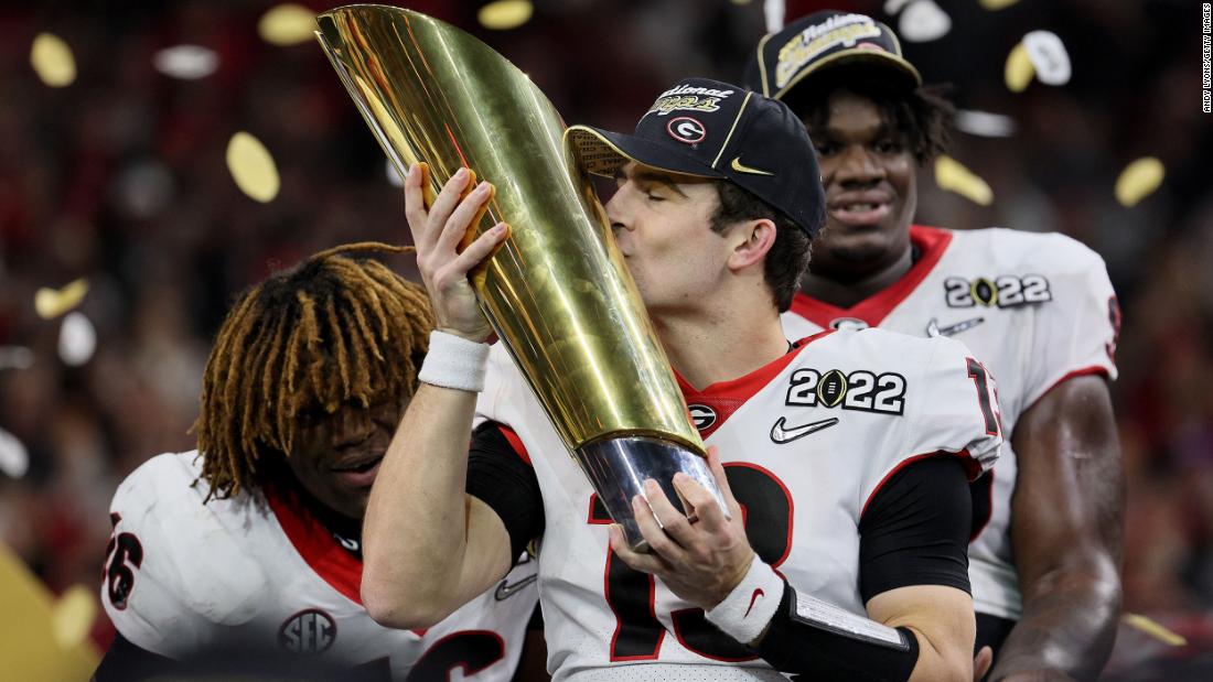 Georgia quarterback Stetson Bennett kisses the National Championship trophy after the Bulldogs defeated Alabama on Monday, January 10. Bennett is a former walk-on who grew up a Georgia fan.