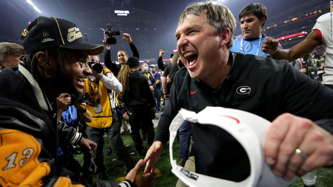 Georgia head coach Kirby Smart is congratulated by former Georgia running back D&#39;Andre Swift during the postgame celebrations.