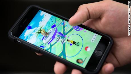 In a 2016 photo, a man plays Pokemon Go game on a smartphone.