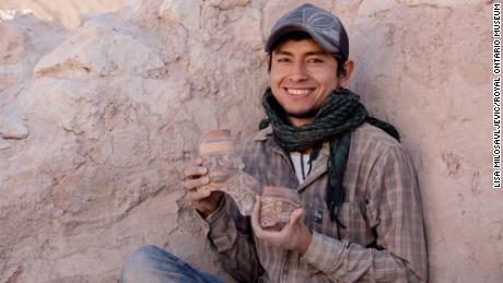 Maico Aybar Villalobos holds fragments of a Robles Moqo vessel that he excavated from Quilcapampa. 