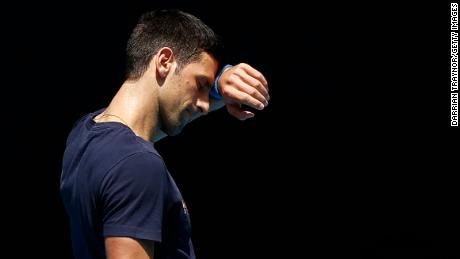 Djokovic wipes his forehead during a training session on Wednesday, January 12.