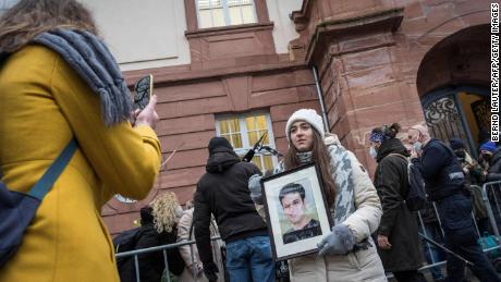 Syrian Campaigner Samaa Mahmoud Shows A Picture Of Her Uncle, Hayan Mahmoud, As She And Others Wait Outside The Courthouse In Koblenz, Western Germany, On Thursday.