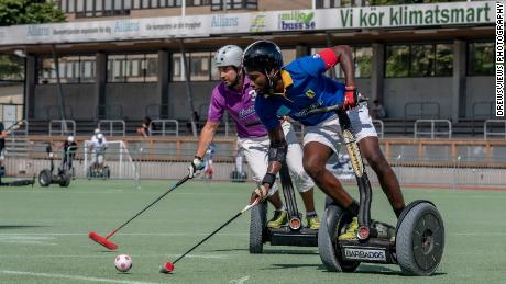 Captain Nevin Roach (in blue) on offense for Team Barbados during the 2019 Segway Polo World Championships, Sweden.