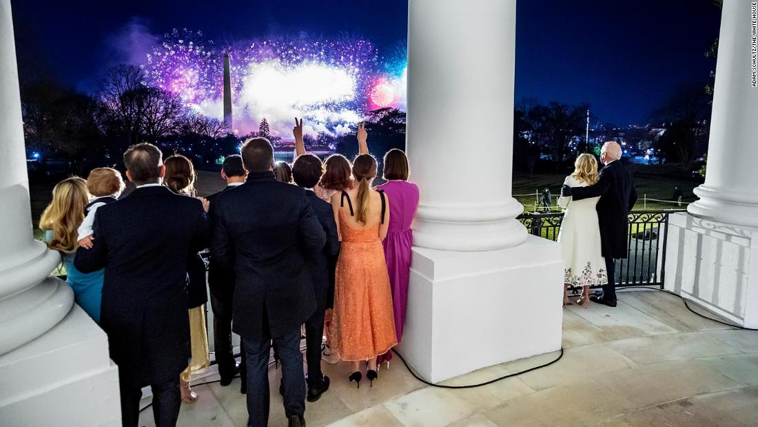 The President and first lady are joined by other members of their family as they watch fireworks from the White House on the night of the inauguration. They were looking out at the Washington Monument from the Blue Room balcony.