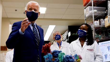 U.S. President Joe Biden speaks next to an NIH staff member as NIH Director Francis Collins listens during a visit to the Viral Pathogenesis Laboratory at the National Institutes of Health (NIH) in Bethesda, Maryland, U.S., February 11, 2021. REUTERS/Carlos Barria     TPX IMAGES OF THE DAY