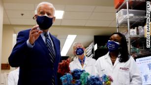 U.S. President Joe Biden speaks next to an NIH staff member as NIH Director Francis Collins listens during a visit to the Viral Pathogenesis Laboratory at the National Institutes of Health (NIH) in Bethesda, Maryland, U.S., February 11, 2021. REUTERS/Carlos Barria TPX IMAGES OF THE DAY